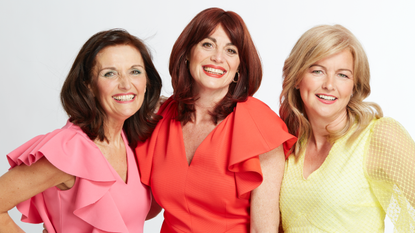 Three smiling women with various colours of hair