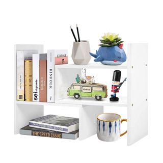 A white desk organizer with accessories on it
