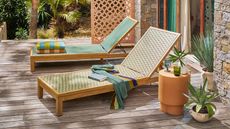 La Redoute sun loungers with colorful woven rattan-like finish with potted plants, and colorful towels on a deck
