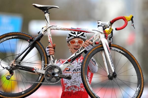 Quinten Hermans lifts his bike in celebration