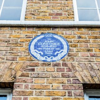 blue plaque in stone wall building