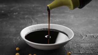 Soy sauce being poured into bowl