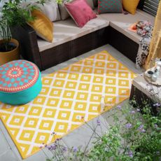 cushions and plant pot and outdoor mat