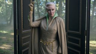 Gwendoline Christie as Principal Weems holding up her left hand and snapping in Wendesday.