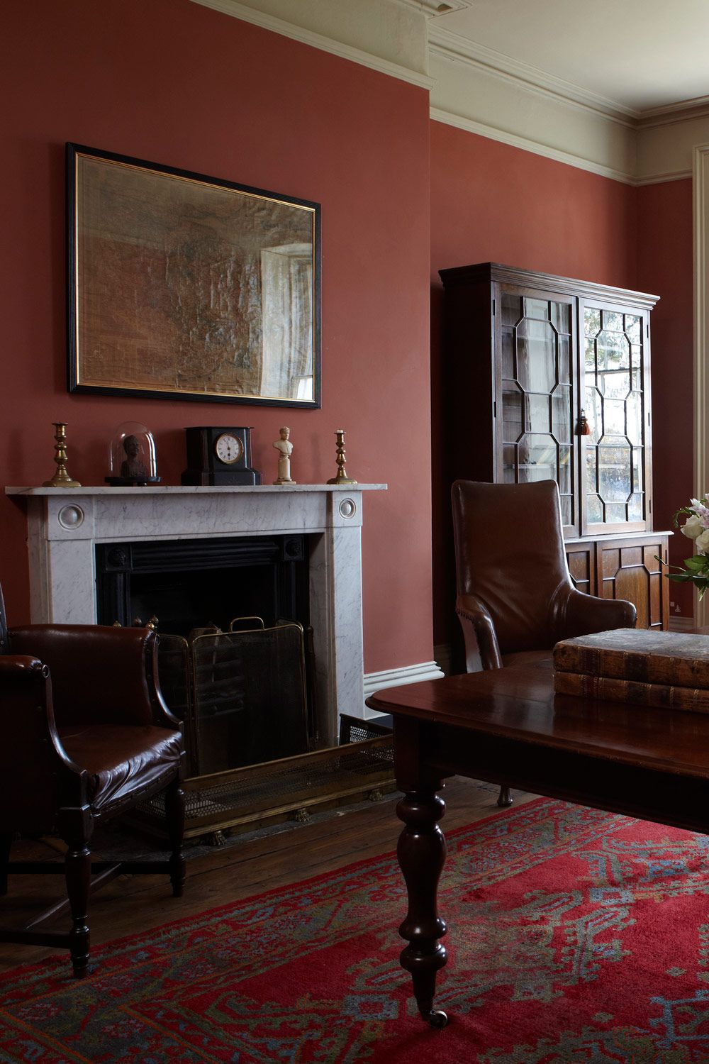 Room painted in Farrow and Ball Book Room Red wall paint shade