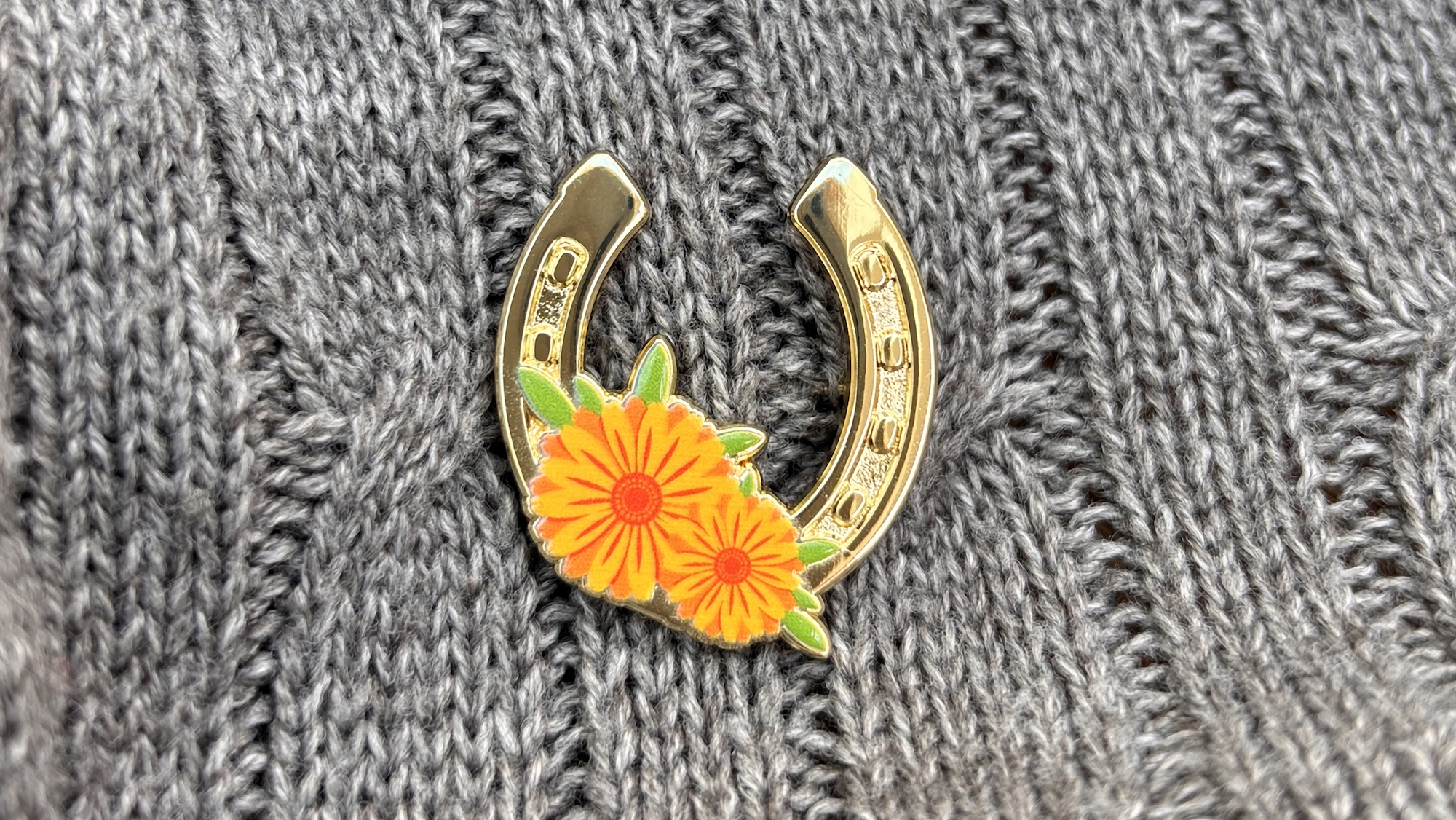 The horseshoe-shaped Every Horse Remembered badge