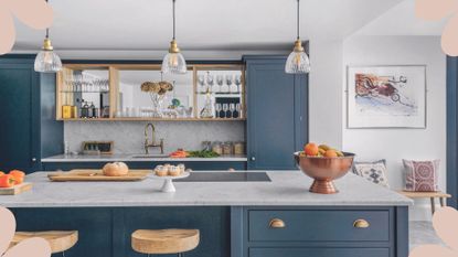 Gray blue kitchen with marble workstops and glass pendants and splashback to support an article on how to clean kitchen cabinets