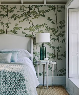 Botanical print wallpaper cozy bedroom ideas with upholstered bed.