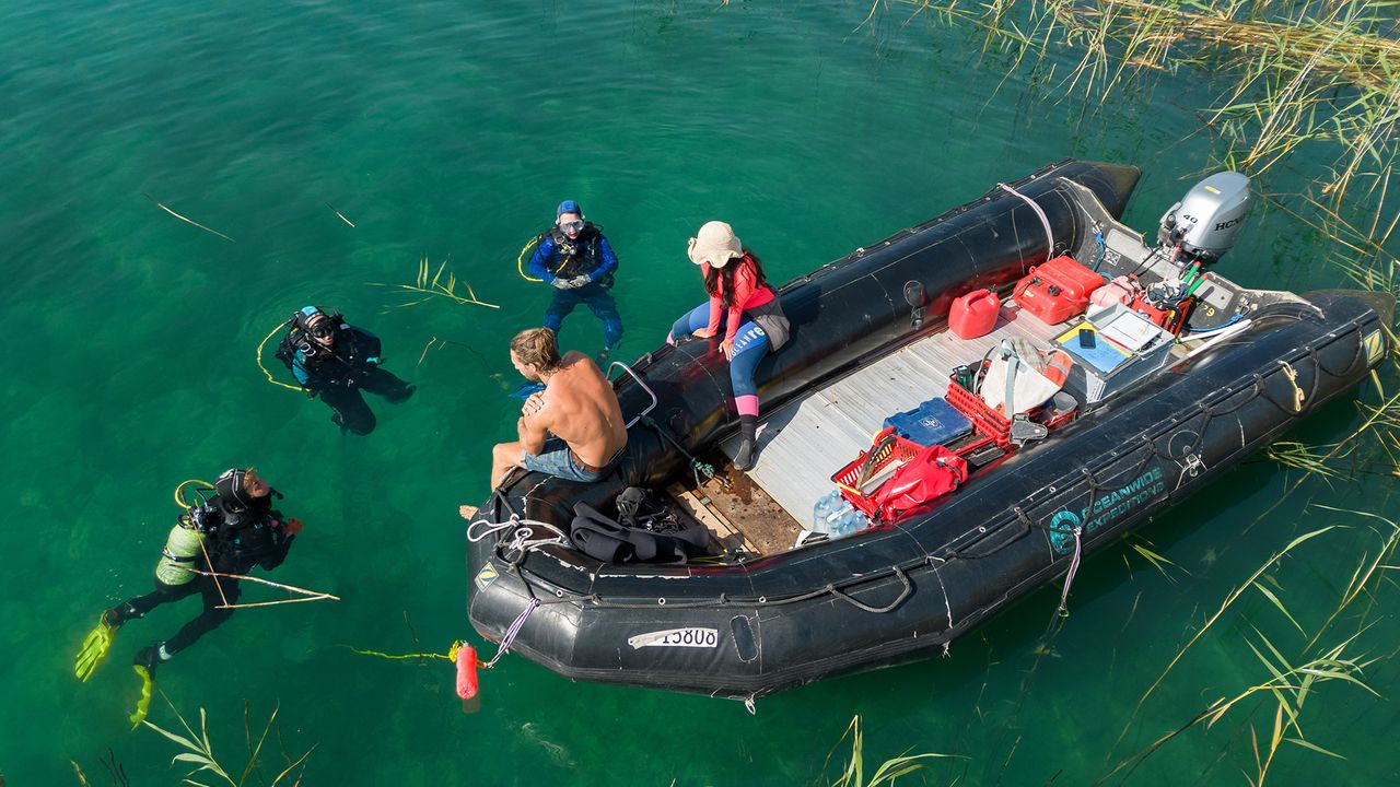 Divers excavate underwater site at possible oldest village in the world.