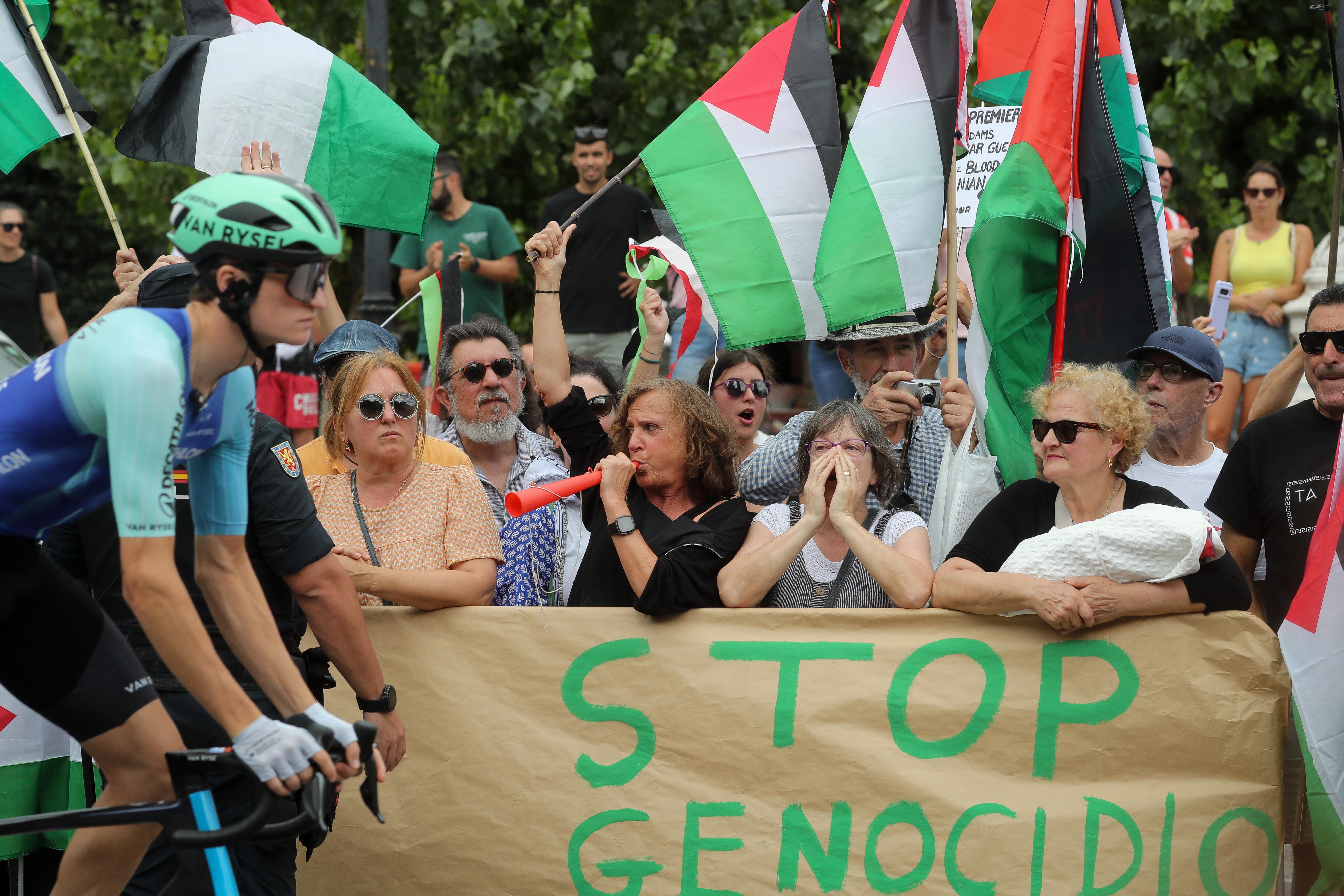 Sign reads &#039;stop genocide&#039; at a cycling race