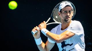 Novak Djokovic returns a tennis ball during a warm up for the Australian Open 2023