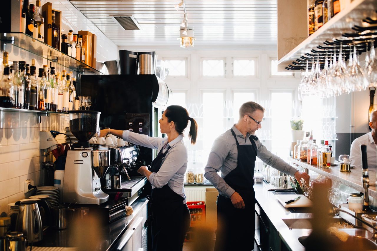 man and woman working in a restaurant - 50 off restaurants eat out help out