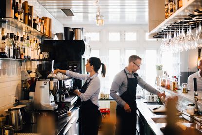 man and woman working in a restaurant - 50 off restaurants eat out help out