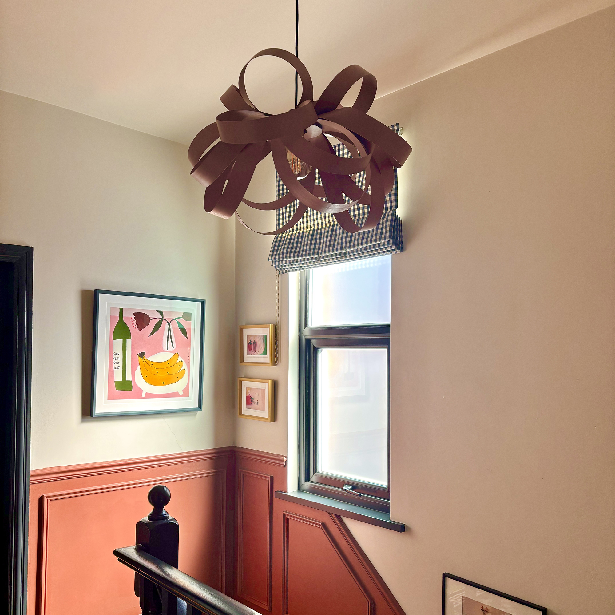 pink hallway with sculptural pendant light