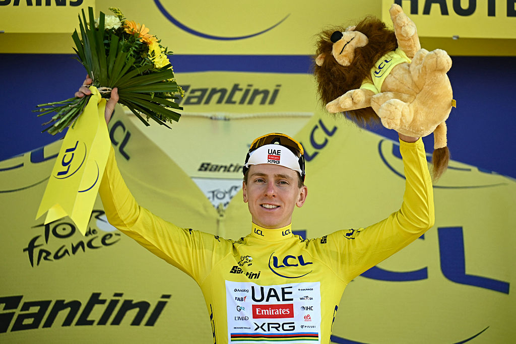 UAE Team Emirates - XRG's Slovenian rider Tadej Pogacar  celebrates on the podium with the overall leader's yellow jersey after the 16th stage of the 113th edition of the Tour de France cycling race, 26 km between &Eacute;vian-les-Bains and Thonon-les-Bains in the French Alps, on July 21, 2026. (Photo by Loic VENANCE / AFP)