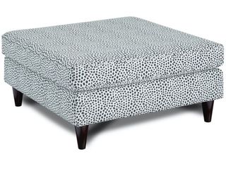 A black and white coffee table ottoman with spotted print motif decor