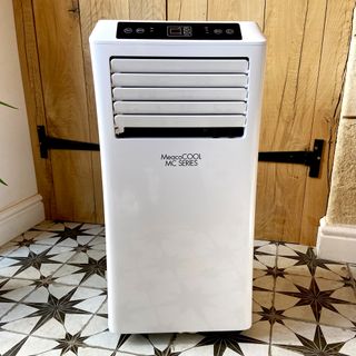 The MeacoCool MC Series 7000BTU Portable Air Conditioner on a white tiled floor with grey star design