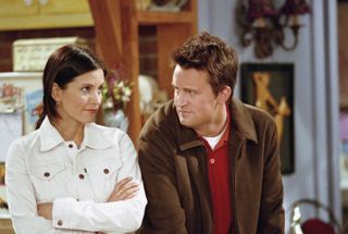 monica wearing a white jean jacket and chandler wearing a suede jacket on friends