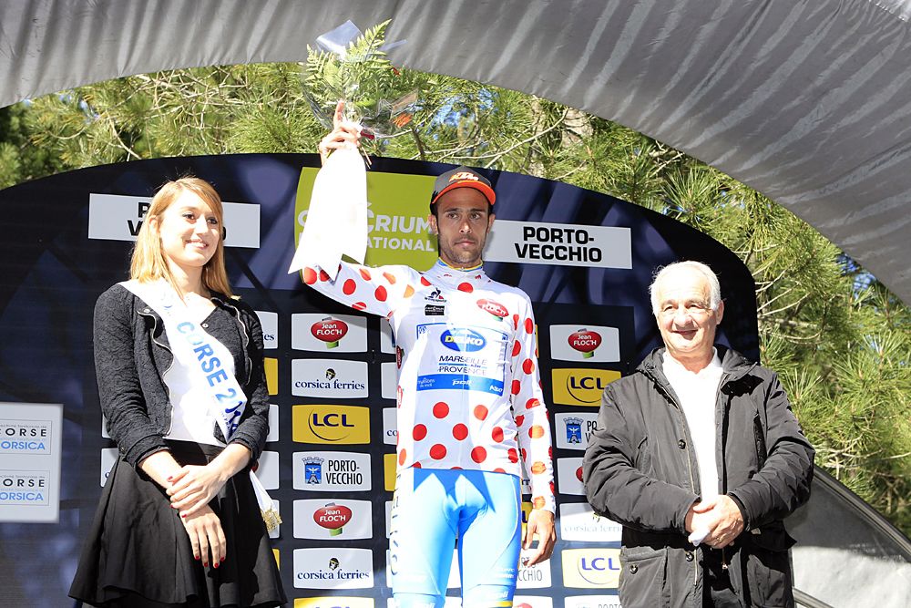 Remy Di Gregorio celebrates his best climber's polka dot jersey on the podium at the end of the third and last stage of the 85th International Criterium of Porto Vecchio