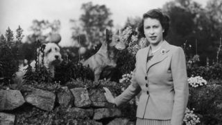 28th September 1952: Queen Elizabeth II poses in the garden of Balmoral Castle with two of her dogs. (Photo by Lisa Sheridan/Studio Lisa/Hulton Archive/Getty Images)