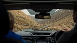 Inside view of a couple driving in the lake district