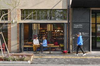 Fotografiska Shanghai by AIM Architecture showing the building's blend of old and new with raw concrete and plush interiors