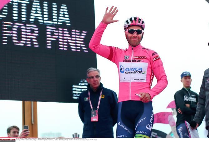 Svein Tuft enjoys a brief moment in the pink jersey before the skies opened up