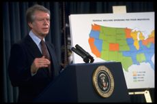 President Jimmy Carter standing next to map of the US 