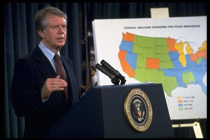 President Jimmy Carter standing next to map of the US 