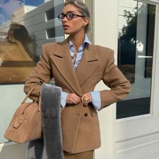 Elsa Hosk wearing a camel blazer from her Revolve brand Helsa.