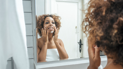 Skincare: Young woman uses sunscreen to beat aging