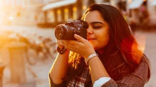 A young woman using what may be the best camera for beginners