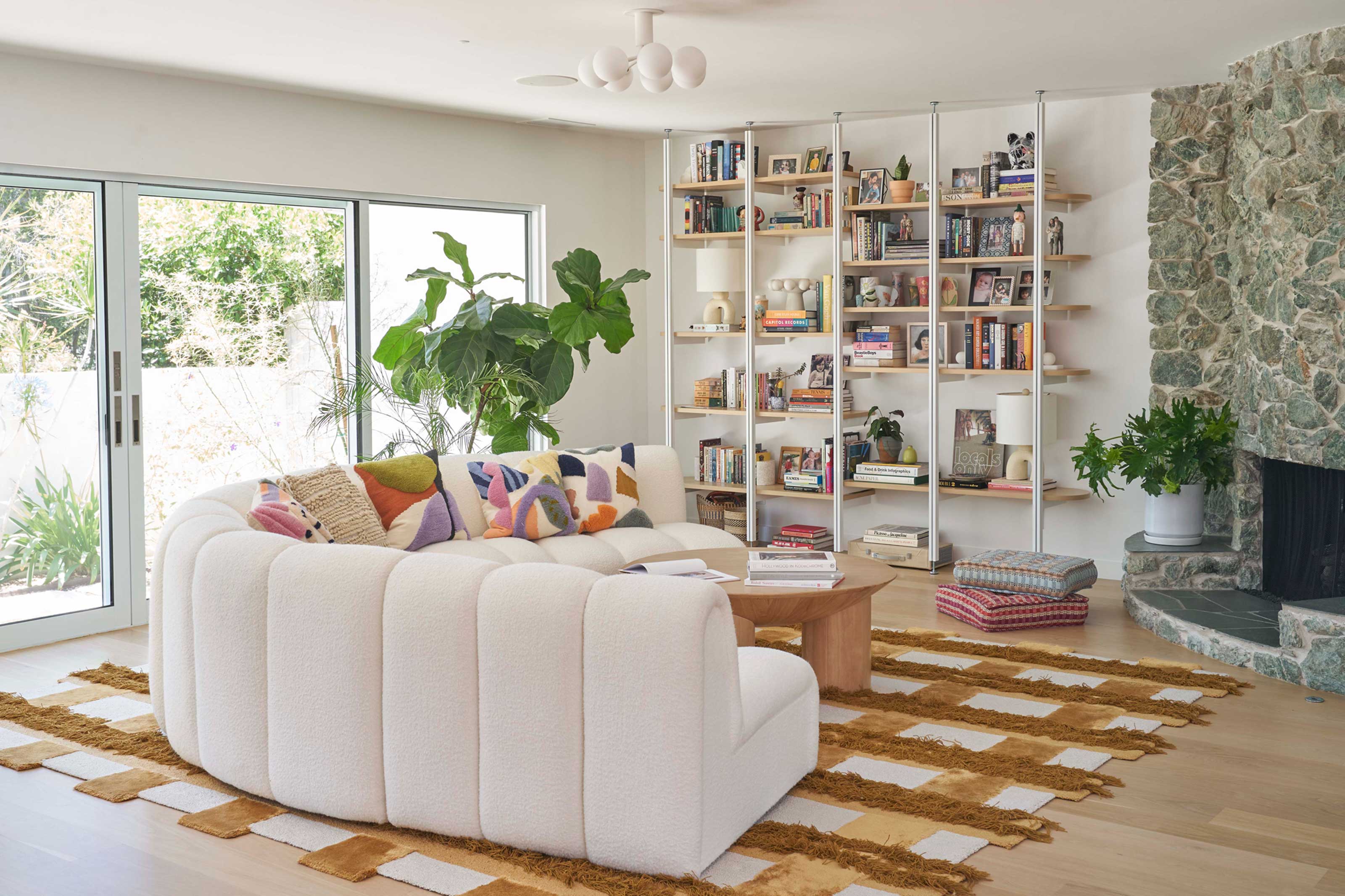 a colorful living room with pillows and a rug