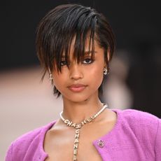 Tyla wearing a pixie cut with bangs and a chanel skirt suit at Paris Fashion Week