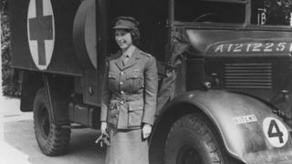 Queen Elizabeth II during WW2, in front of an army vehicle