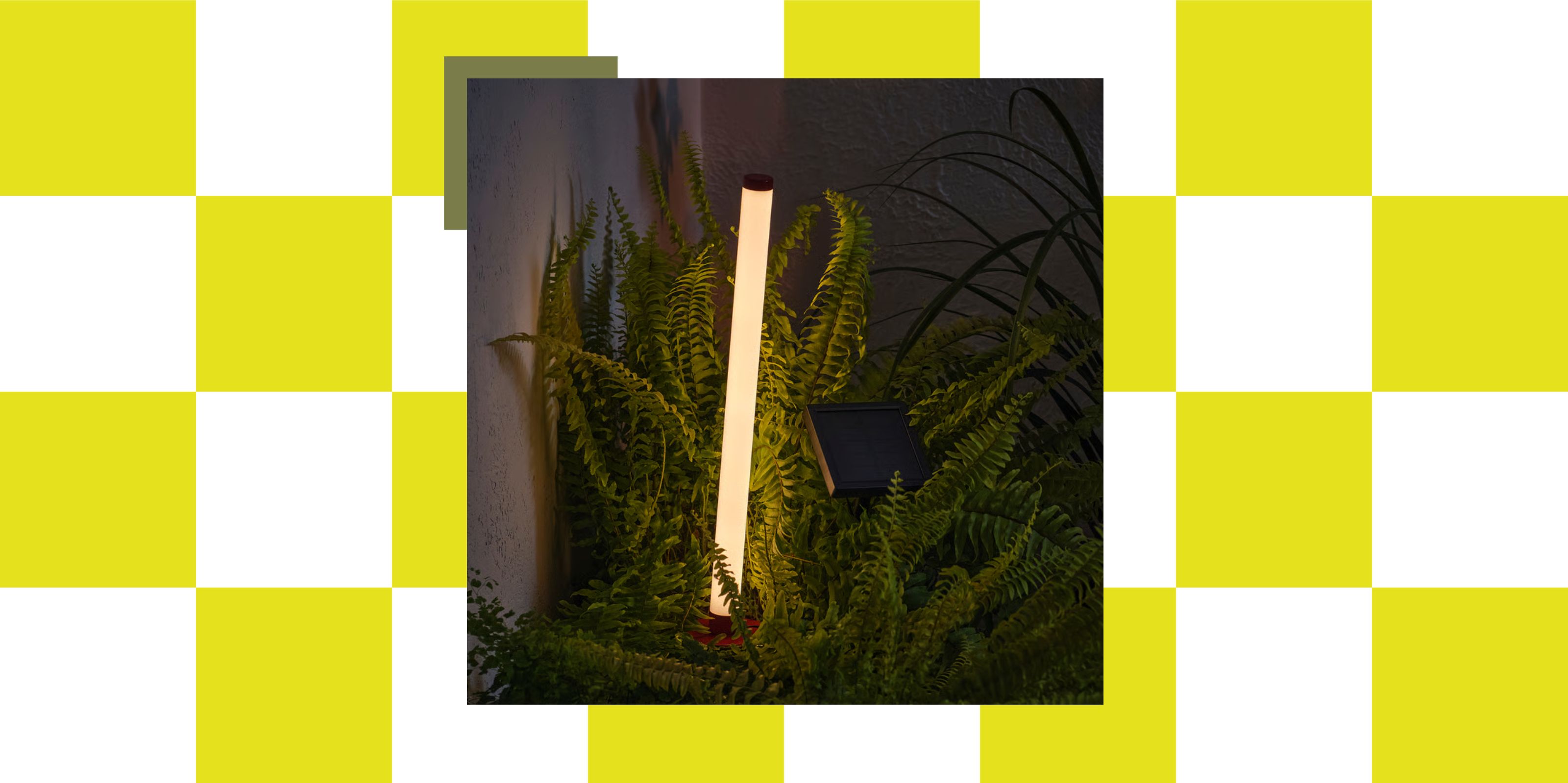 IKEA's SOLVINDEN Solar-powered ground stick in amongst ferns at night in a garden corner