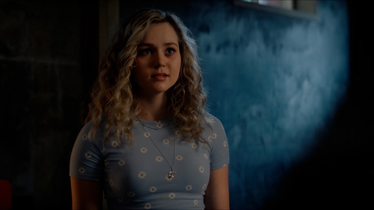 Courtney standing around in the darkness in Stargirl