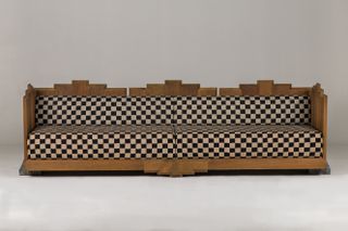 Sofa with wooden structure and black and white checkered textile upholstery by Cristián Mohaded