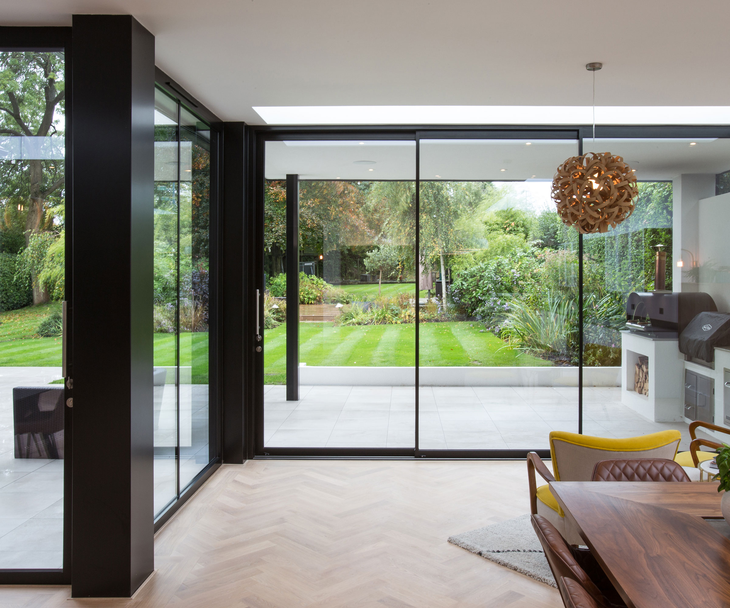 kitchen extension with contemporary sliding glass doors leading out to a patio and garden
