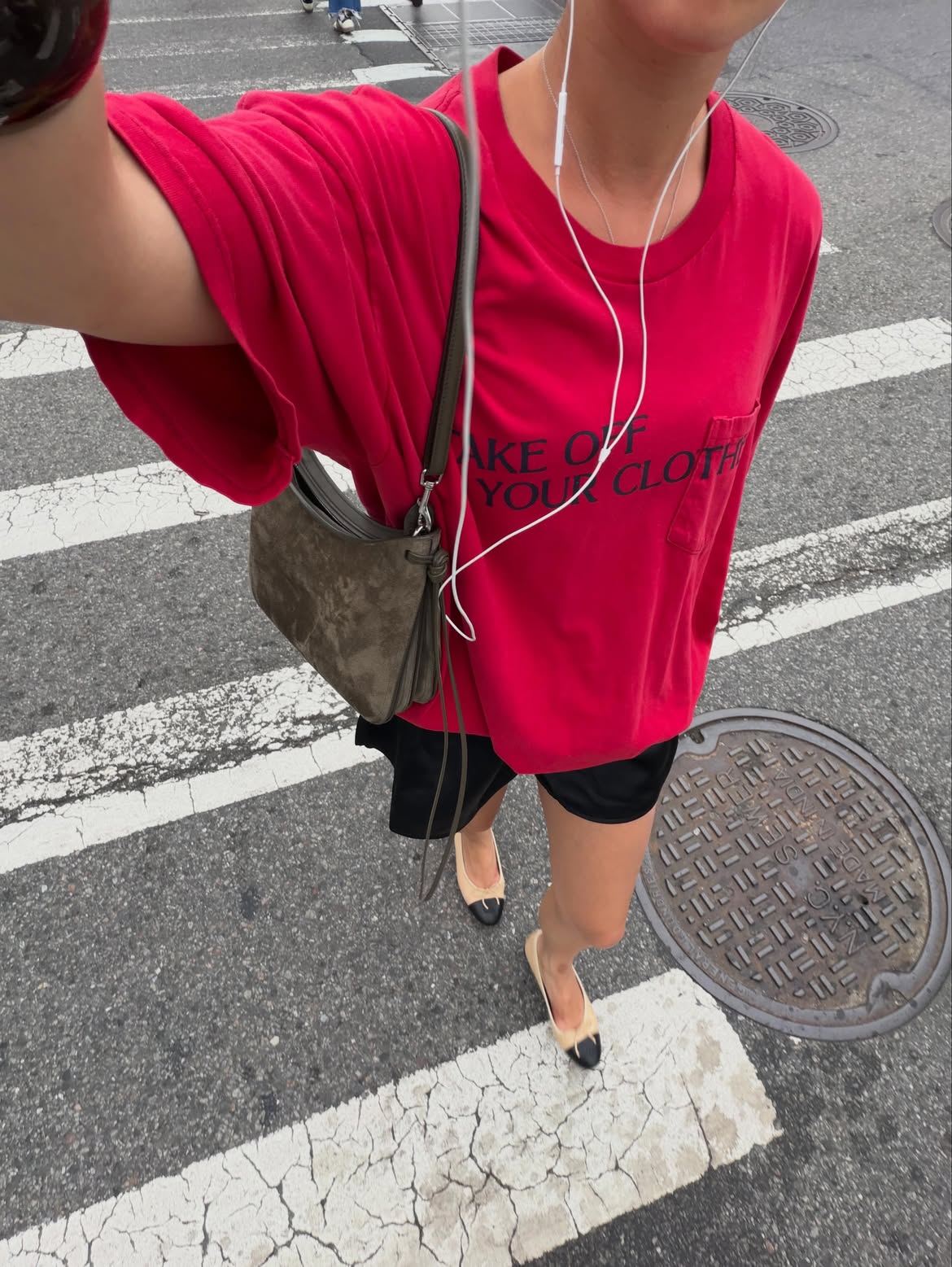 Sasha Mei wearing a red graphic T-shirt from Emily Dawn Long