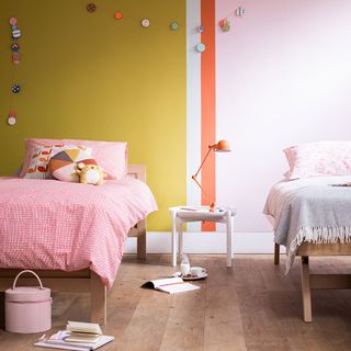 kids room with yellow wall and wooden flooring