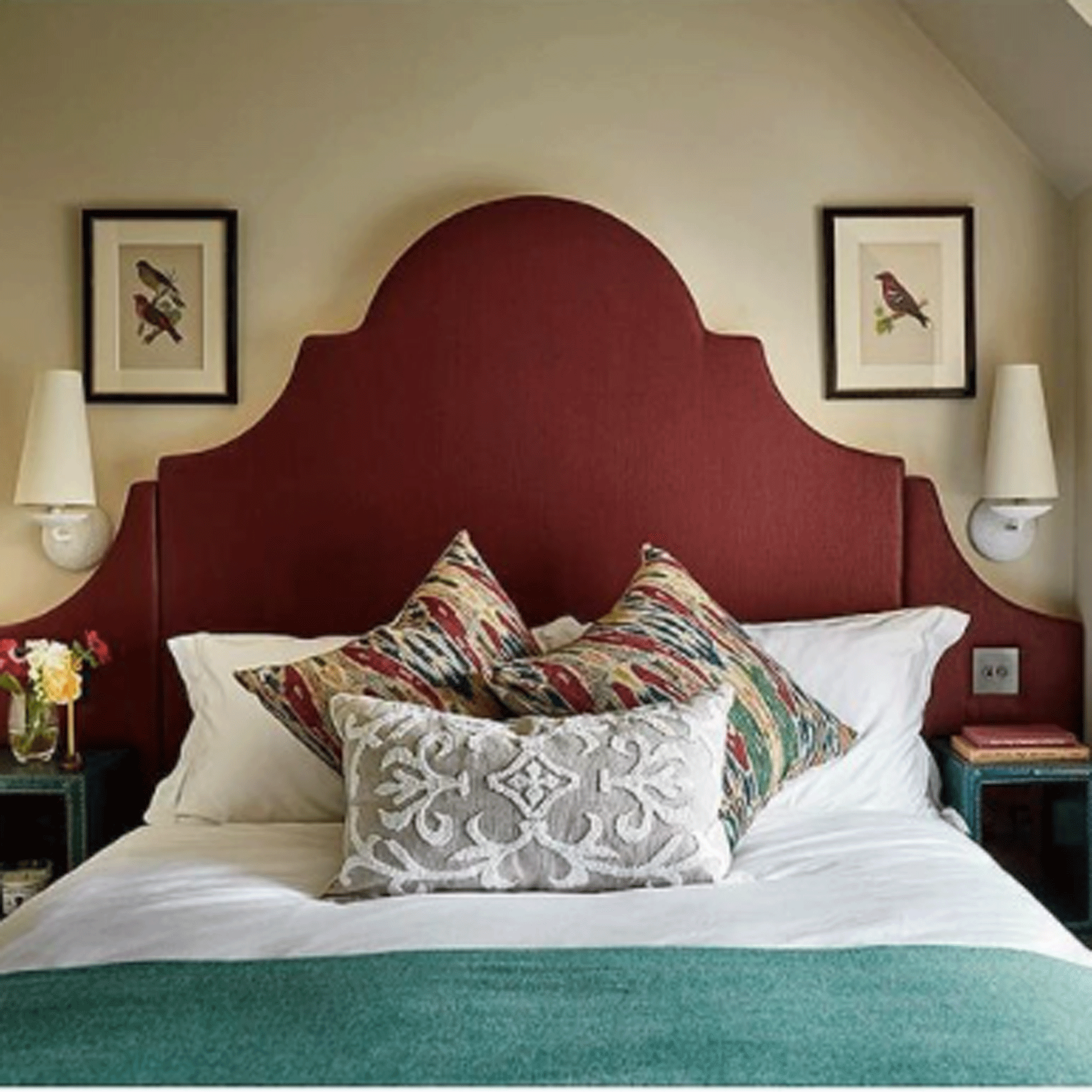 Bedroom with red headboard and teal throw