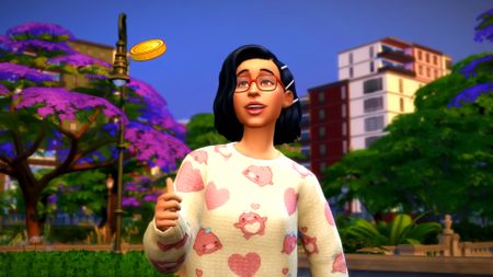 The Sims 4 Lovestruck gameplay trailer screenshot showing a young woman with short black hair and a white/pink heart sweater flipping a golden coin in the air while smiling