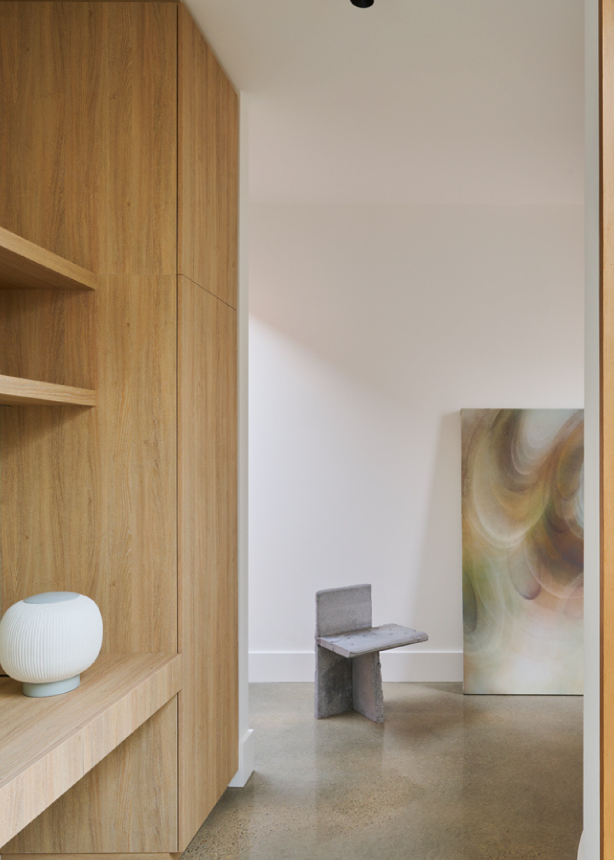 A wooden linen closet attached to a study space