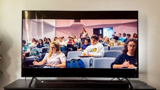 Panasonic W95A TV on table in living room