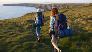 Low impact workouts: Two women hiking along a cliff