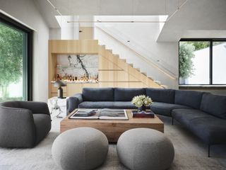 A living room with a curving sofa and a wooden, rectangular coffee table in the middle