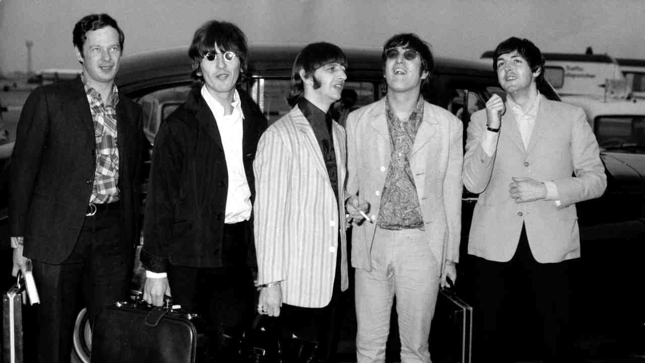 The Beatles posing for a photograph in 1966