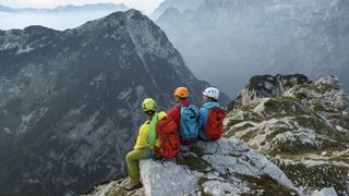 three climbers on a cliff edge
