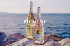 Two bottles of wine, white and ros&eacute;, on a rock with sea in the background, and 'Piccini' written in white over the top